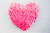 Close up of a pink heart shaped pillow