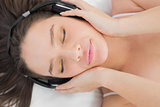 Woman enjoying music in bed