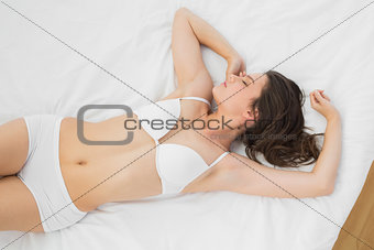 Beautiful woman sleeping in lingerie on bed
