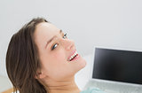 Cheerful young woman with laptop