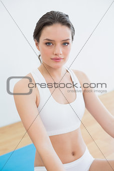 Toned brunette sitting at fitness studio