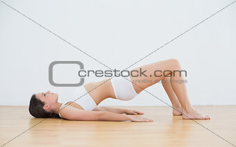 Woman doing the bridge pose in fitness studio