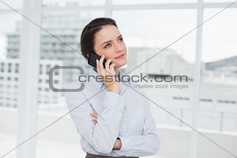 Elegant businesswoman using cellphone in office