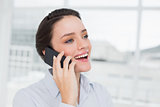 Close up cheerful elegant young businesswoman using cellphone