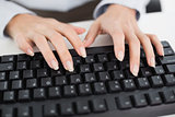 Close up of hands typing on a keyboard
