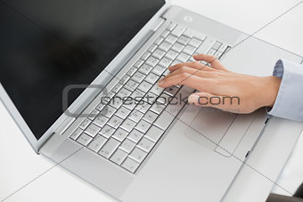 Close up of a hand using laptop