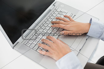Close up of hands using laptop