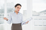 Elegant businesswoman with graphs in office