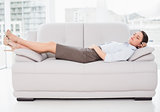 Well young woman sleeping on sofa at home