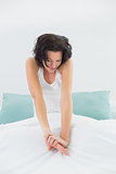 Woman stretching her arms in bed