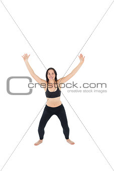 Sporty woman about to jump over white background