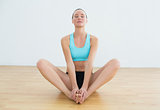 Woman doing the butterfly stretch with eyes closed