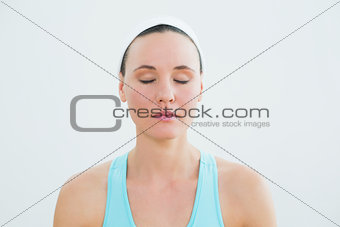 Woman with eyes closed at fitness studio