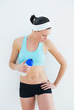 Fit young woman holding water bottle