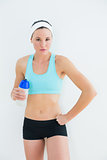 Portrait of a fit woman holding water bottle