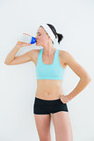 Sporty fit young woman drinking water