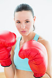 Close up portrait of a beautiful woman in red boxing gloves