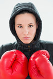 Beautiful woman in hood and red boxing gloves