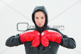 Beautiful woman in hood and red boxing gloves