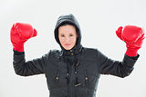Smiling beautiful woman in hood and red boxing gloves