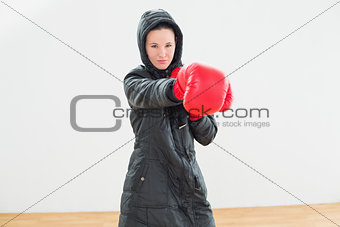 Determined boxer practicing in fitness studio