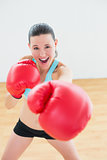 Smiling boxer practicing in fitness studio