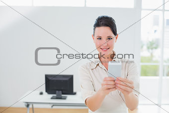 Smiling businesswoman holding a cellphone office