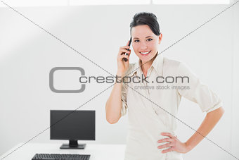 Smiling businesswoman using cellphone in office