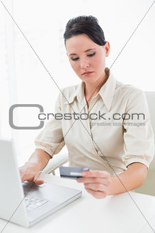 Young businesswoman doing online shopping