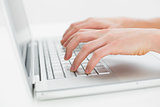 Close up of hands typing on laptop keyboard