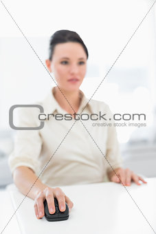 Portrait of a young businesswoman using computer mouse