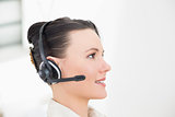 Close up side view of a beautiful businesswoman using headset
