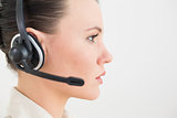 Close up side view of a beautiful businesswoman using headset