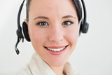 Close up of a smiling beautiful businesswoman using headset