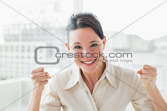 Elegant and happy businesswoman in office
