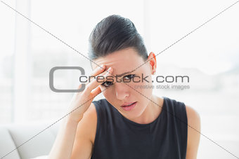 Close up portrait of a businesswoman suffering from headache