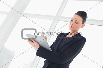 Elegant businesswoman writing notes in office