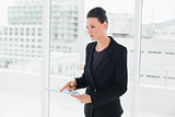 Elegant woman holding a document in office