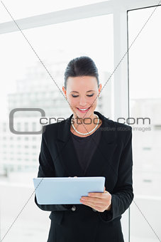 Elegant businesswoman using tablet PC