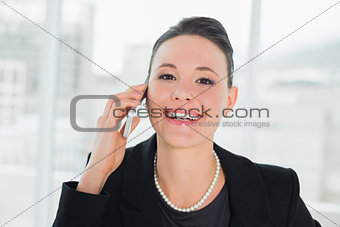 Close up of a smiling elegant businesswoman using cellphone