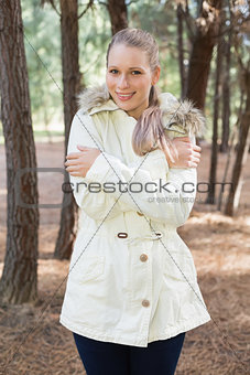 Woman shivering while having a walk in a forest