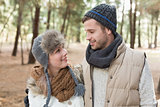 Couple in winter clothing in the woods