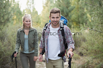 Fit young couple exploring the woods