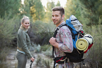 Fit young couple exploring the woods