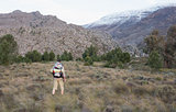 Man with backpack walking on forest landscape