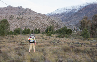 Man with backpack walking on forest landscape