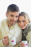 Loving couple in winter clothing with coffee cups