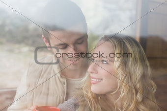 Loving couple seen through cabin window