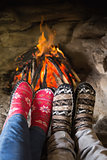 Romantic couple's legs in socks in front of fireplace