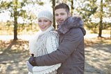 Loving young couple in winter clothing in the woods